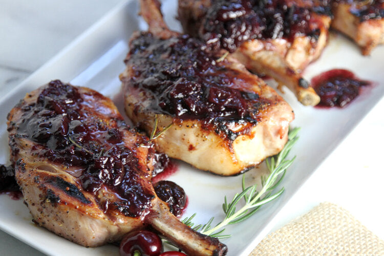 Grilled pork chops glazed with Bald Eagle Foods Raspberry Chipotle Sauce